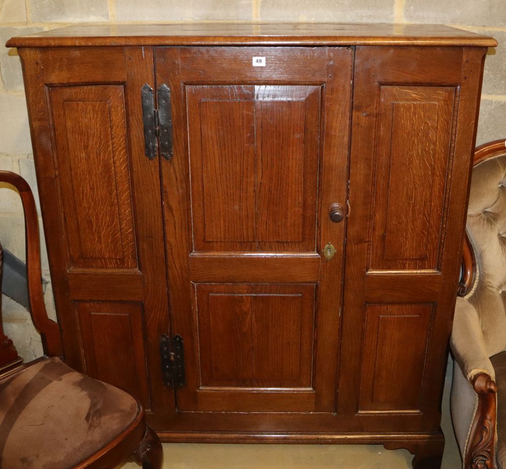 An 18th century and later oak cupboard with single panel central door, W.120cm, H.137cm